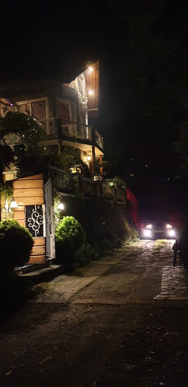 The lantern-lit lane leading up to La Belle Vie after dark